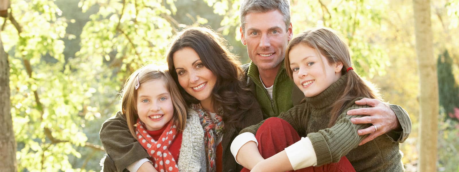 Family of four smiling